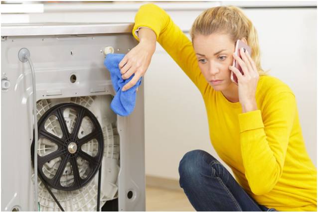 Woman with washing machine making call
